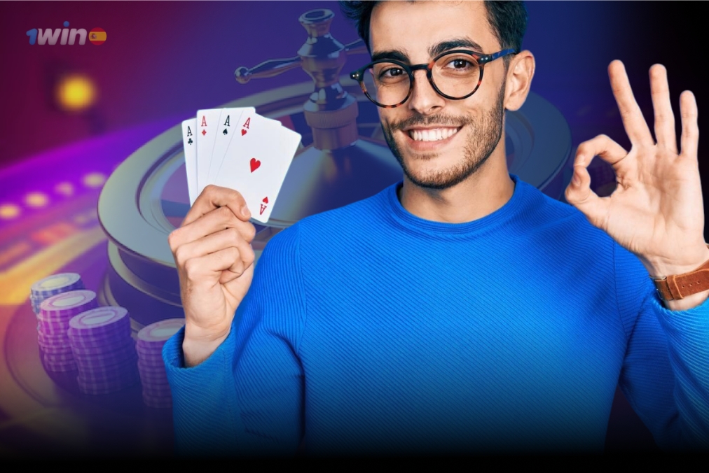 A man holds playing cards in one hand and flashes a peace sign with the other, exuding a cheerful demeanor.
